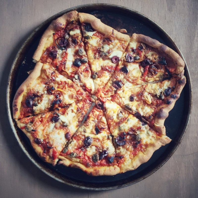 Red sauce. Mozzarella. Caramelized onion, fennel and garlic. Sweet peppers. Capers. Anchovies. Olives.